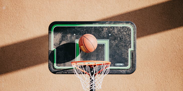 A man dribbling a basketball on a court.