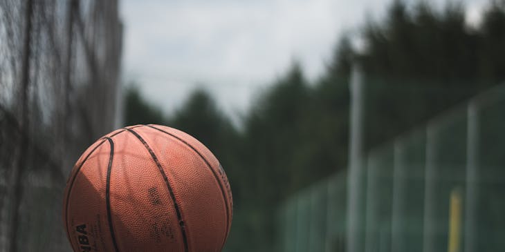 Brown NBA basketball on a concrete surface.