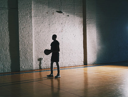A young man at a basket training center.