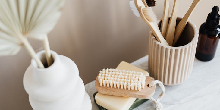 A set of bath and body products on a marble tabletop.