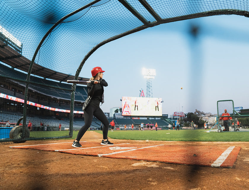 woman practicing in batting cage