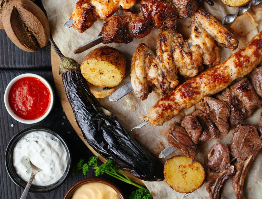 Platter containing grilled meats and vegetables.