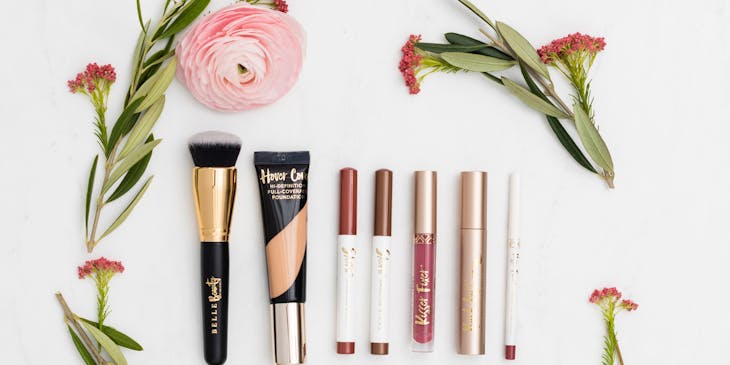 Various beauty business products surrounded by flowers.