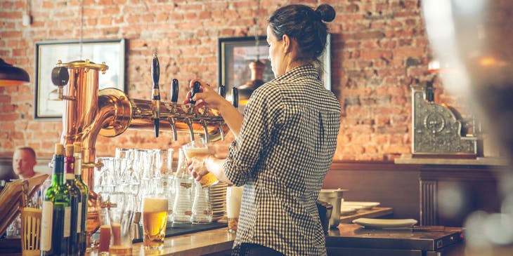 Bartender tapping beer at a beer bar.