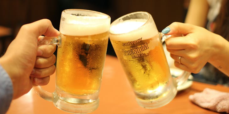 Beer mugs clinking during a beer tour.