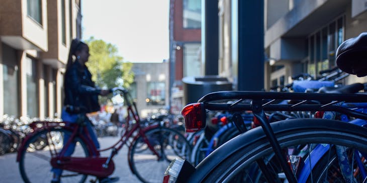 Bicycles lined up at a bike parking station.