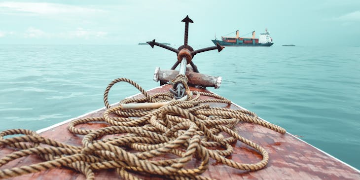 A boat on water loaded with parts and supplies.