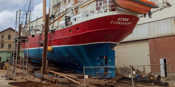 A vessel on land undergoing boat repairs.