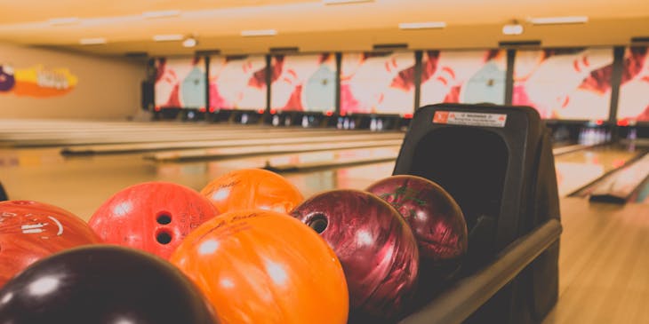 Bowling balls at a bowling alley.