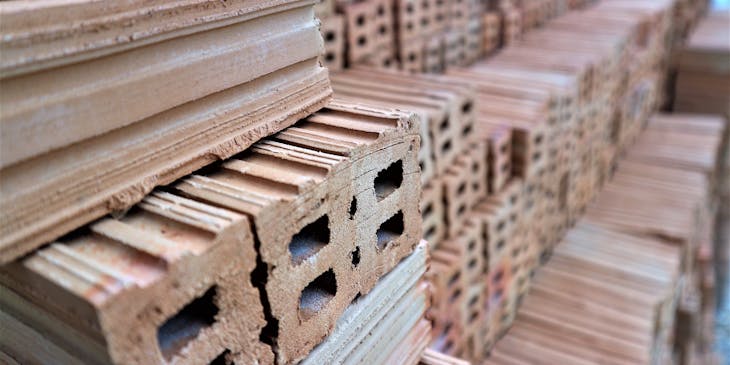 Stacked textured bricks at a building supplies business.