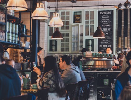 Café with several tables filled with patrons.