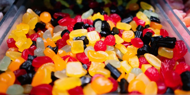 Colorful assorted candies on a glass tray.