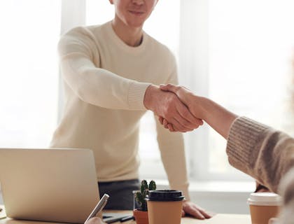 Two individuals shaking hands.