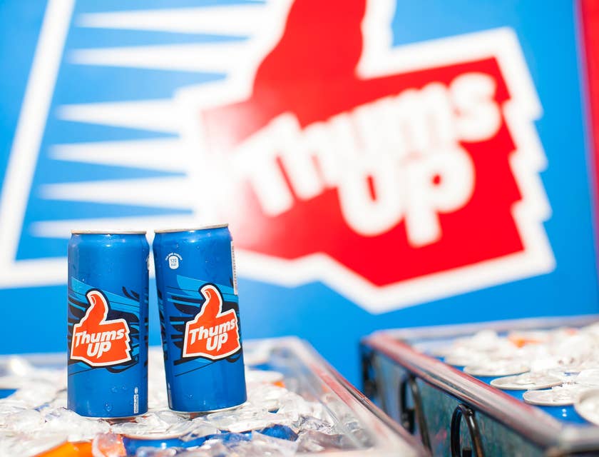 Two small beverage cans labeled "Thums Up."