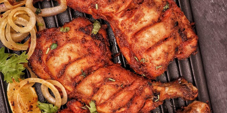 A plate of grilled chicken served at a chicken restaurant.