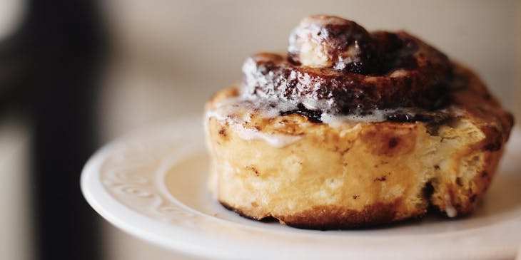 Cinnamon roll on a white plate.
