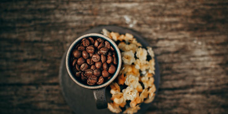 Coffee beans in a mug at a coffee roastery.