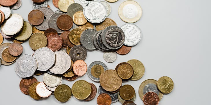 Assorted coins scattered on a surface