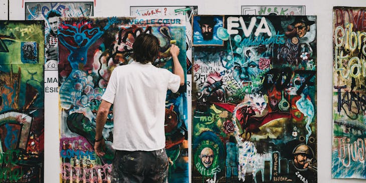 A commissioned artist finishing a painting.