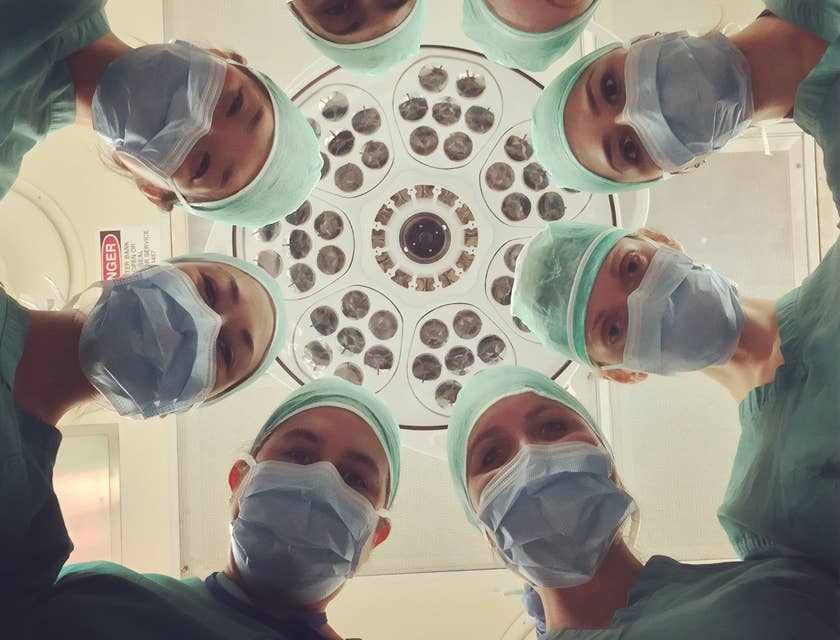 Un groupe de praticiens de la conciergerie médicale regardant vers le bas une caméra.