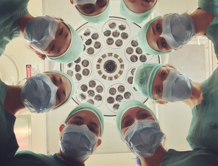 A group of concierge medicine practitioners looking down at a camera.