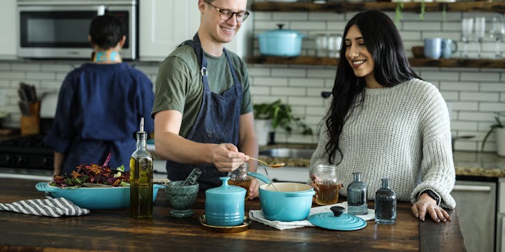 Man and woman in a kitchen at a cooking school.