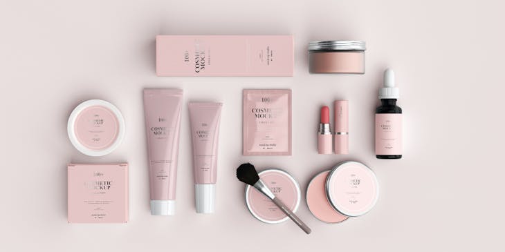 Various neatly-arranged cosmetics products in pink and white packaging.