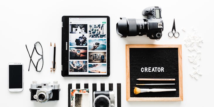 Creative design materials and equipment on white background.