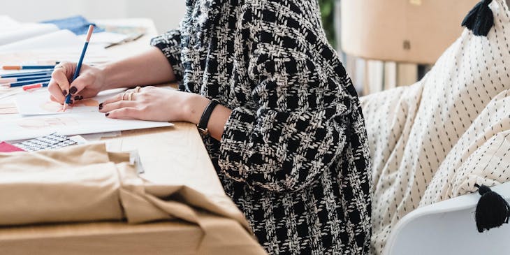 A young woman drawing a sketch in her design studio.
