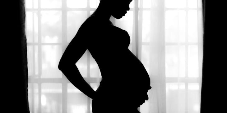 Silhouette of pregnant woman at a crisis pregnancy center.