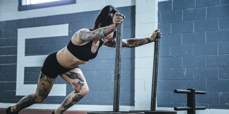A woman pushing CrossFit business equipment