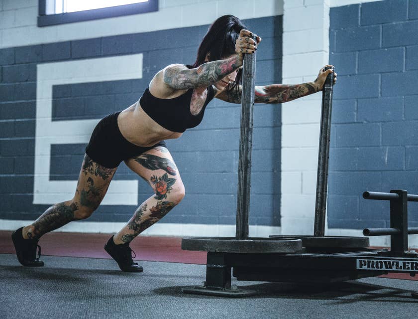 A woman pushing CrossFit business equipment