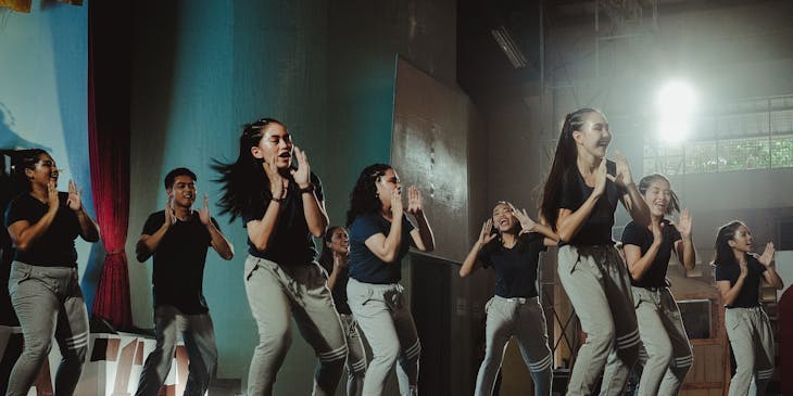 A group of girls rehearsing in a dance studio.