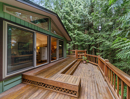 Backyard deck with wooden railings.