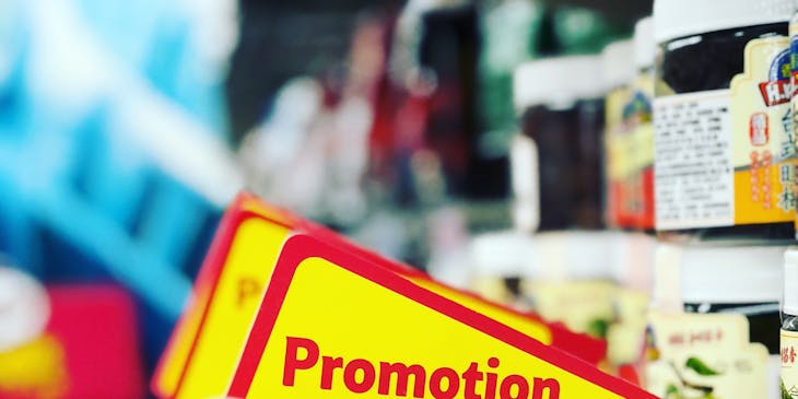A discount store with red and yellow promotion signs.