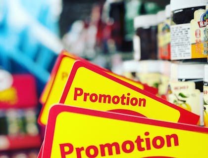 A discount store with red and yellow promotion signs.