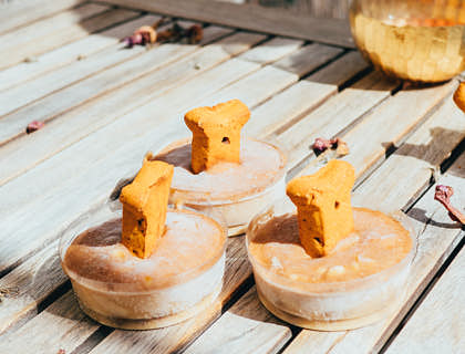 Dog treats laid out on a wooden table.