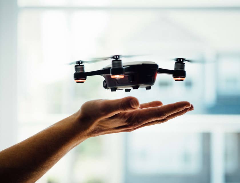 A drone hovering over a hand.