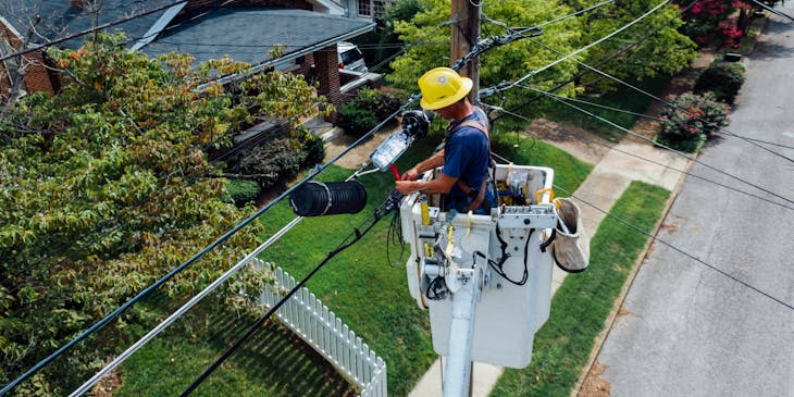 An electrician maintaining electric cables.