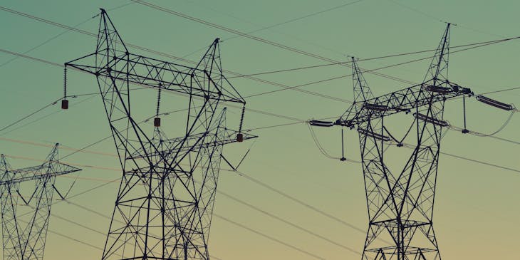 Electricity transmission towers supporting overhead powerlines.