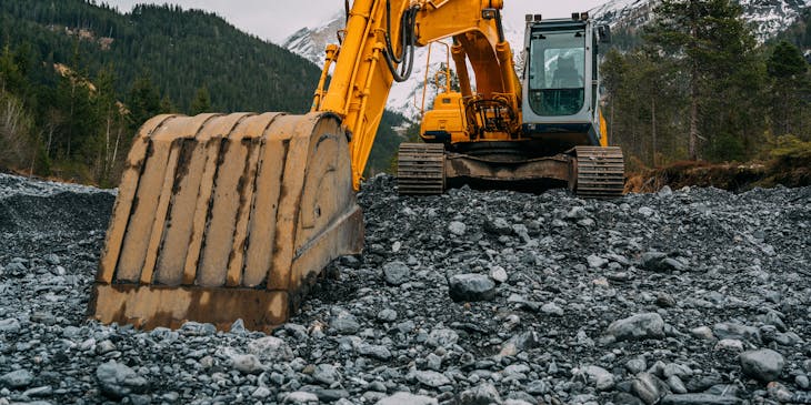 Excavator doing environmental abatement in a mountain stream bed.
