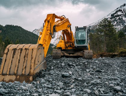 Excavator doing environmental abatement in a mountain stream bed.