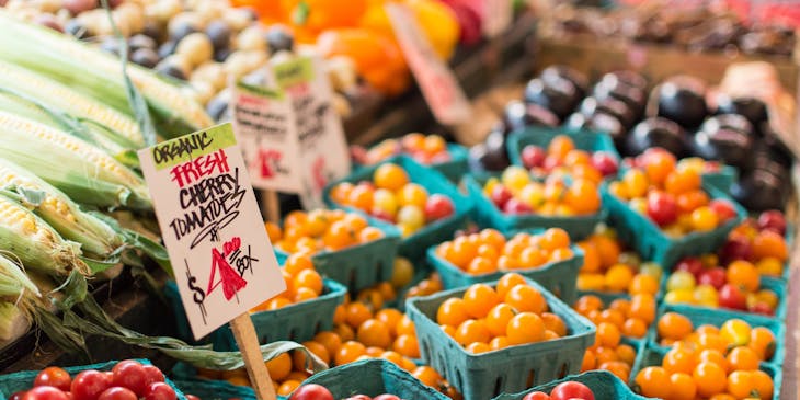 A line of produce at a farmers market.
