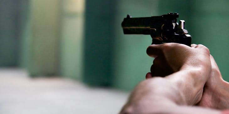 Man holding a firearm.