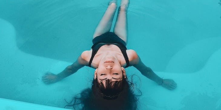 A woman relaxing in the pool of a float spa.