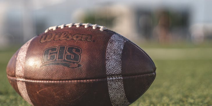 Close-up of a football on a football field.
