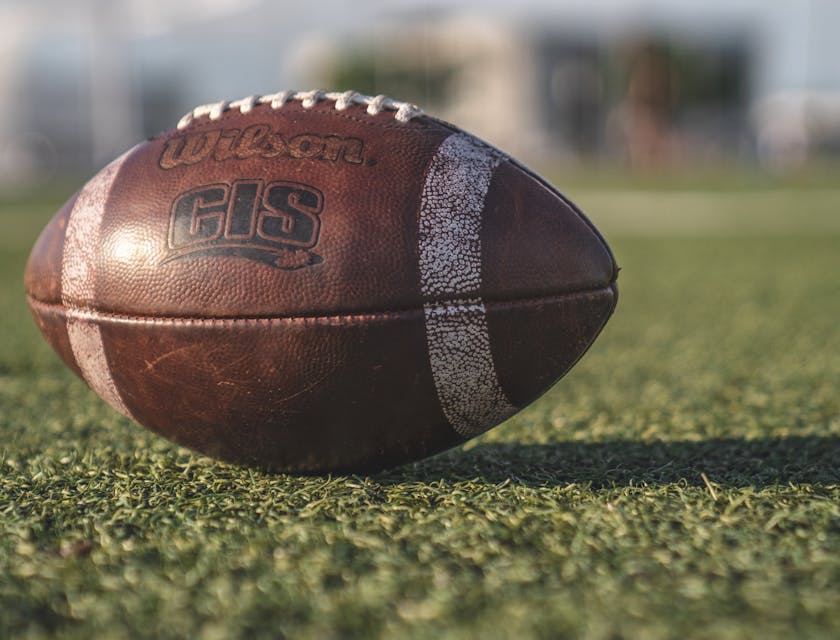 Close-up of a football on a football field.