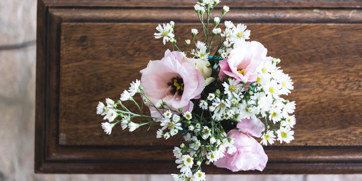 Flowers on a coffin at a funeral service.