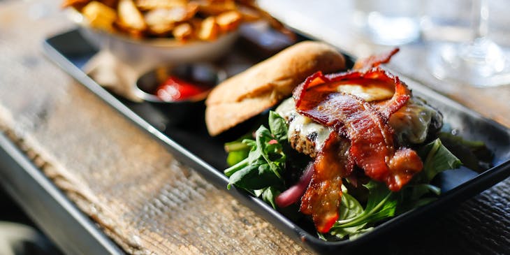 A gourmet burger and fries platter served at a gastropub.