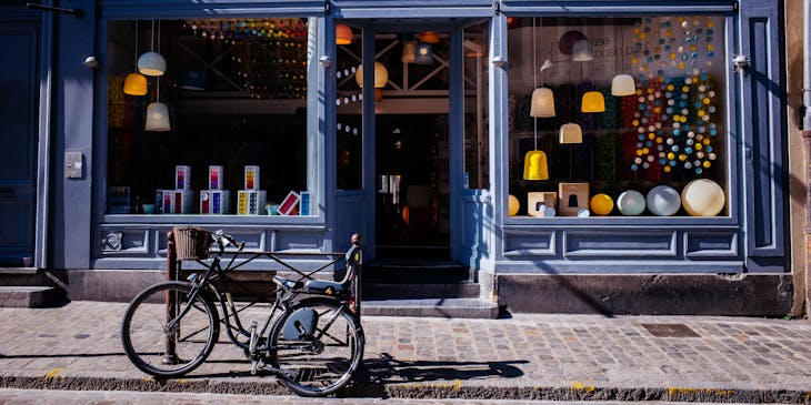 A general store with a bicycle in front of it.